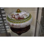 An early 20th Century Japanese Cloisonne enamel bowl with bird and blossom detail with lid on stand