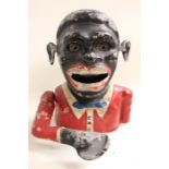 A cast iron man money box, with working arm and eyes, painted finish