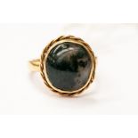 A 9ct gold and moss agate ring, round moss agate with a rope border, size N, total gross weight