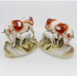 A pair of late 19th Century Staffordshire cow and calf groups, red and white colours