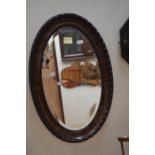 A 20th century mahogany oval mirror