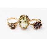 Three 9ct gold dress rings, one set with an oval citrine, one garnet set cluster and a smoky