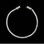 A diamond tennis bracelet, rub-over set with approx 7'', fifty six round brilliant cut diamonds,