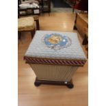 A 19th Century footstool with hinged top and tapestry seat with leopard head detail