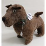 A 1920 straw stuffed plush terrier dog