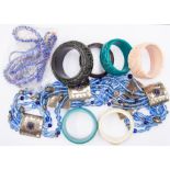 A collection of costume jewellery to include possibly Bakerlite and plastic bangles, glass beads and