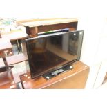 A flat screen TV Samsung with controllers
