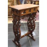 A mahogany table with carved foliate supports.