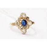 A  sapphire and diamond cluster, comprising an oval sapphire with a old cut and rose cut border,