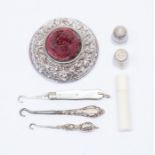 Sewing; pin cushion Birmingham 1904, folding button hook, Sheffield 1901, James Fenton, needle case,