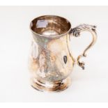 A silver tankard, embossed leaf decoration to handle, height approx 130mm, Birmingham 1865,