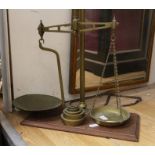 Brass weighing scales on wooden plinth and brass weights