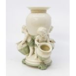 Late 19th Century Royal Worcester centrepiece vase with three cherub figures holding vase/urns