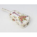 A porcelain cello shaped trinket box and cover
