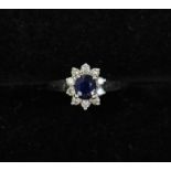 An 18k white gold, diamond and sapphire cluster ring, size N, approx 3.8 grams