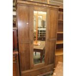 Late Victorian mirrored wardrobe in Oak, with linenfold carving. Single draw to base.