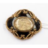 A Victorian yellow metal mourning brooch, enamel and hair window, inscribed to reverse, dated