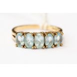 A blue topaz and 9ct gold dress ring, set with five graduated blue topaz, size R, total gross weight