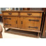 Arts and Crafts Oak sideboard. Two drawers, two large cupboards, with decorative hinges and