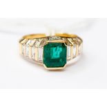 An emerald and diamond ring, set with an emerald cut emerald, weight approx 2.14 carat, tiered