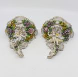 A pair of late 20th Century Dresden wall sconces with cherub and floral relief detail, 17 cms high