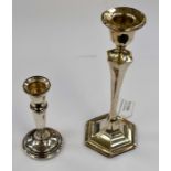 A pair of weighted silver candlesticks, hexagonal form with tapered stems, makers mark indistinct,