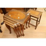 Nest of four tables with decorative carving in Mahogany.