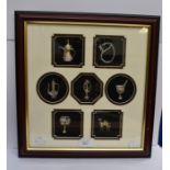 A framed collection of Saudia Arabian silver memento's (2 dimensionsal)