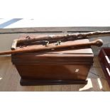 A late 19th Century table top sewing machine, with two walking sticks