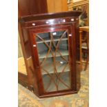 A mahogany glazed hanging corner cupboard.