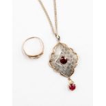 A silver drop pendant with scalloped rose gold border, set to the centre with a round cut garnet and