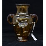 A late 19th Century amber glass twin handled vase in the style of Moser, enamelled fish