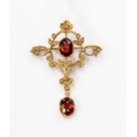 A Edwardian garnet and seed pearl brooch, open work set with seed pearl decoration set to the centre