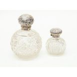 Two Edwardian cut-glass silver topped perfume bottles, London 1908 and Birmingham 1903 (lid