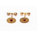 A pair of 9ct gold and garnet set cufflinks, oval with chain and bar components, inscribed J.H