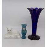 A Bristol blue coloured tulip vase, 28 cms high approx, hand vase and glass white cat statue