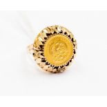 A five pesos coin ring, set in 9ct gold fancy mount, size P, total gross weight approx 9.6 grams