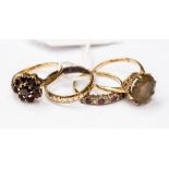 A collection of four rings to include a 9ct gold band, 9ct gold smoky quartz ring and a 9ct gold and