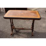 A Victorian burr walnut library table on fluted supports and stretchers on cabriole feet on white