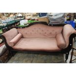 A mid Victorian Carved Mahogany Settee, c.1870, pink upholstery raised on turned supports on