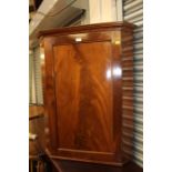 A mahogany hanging corner cupboard.