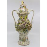 A late 19th Century Continental vase with top heavily decorated with flowers