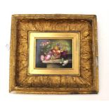 Hand painted porcelain plaque of flowers and fruit in a gilt wood frame. Possibly derby porcelain.