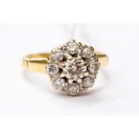 A diamond set cluster ring, centre brilliant cut weighing approx 0.40ct, with a diamond claw set