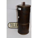 A telephone sign and scroll/bottle case