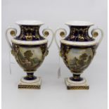 A pair of Royal Crown Derby two handled vases, with hand painted landscape scenes and gilt detail
