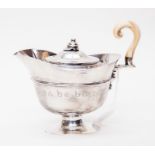 An early Victorian London silver water pot, with ivory handle, in the form of a helmet, with the