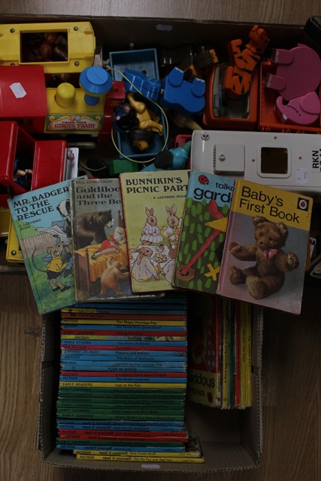 A collection of Playmobil toys together with assorted Ladybird books. (two boxes)