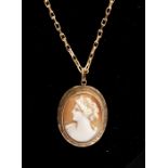 A 9ct gold cameo pendant early 20th Century,  set within an engraved border of unmarked yellow metal