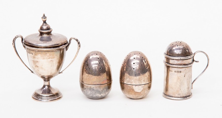 A pair of egg shaped silver pepper pots, marks worn probably Birmingham 1901, Deakin & Francis